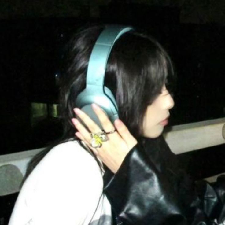 a woman with black hair wearing headphones