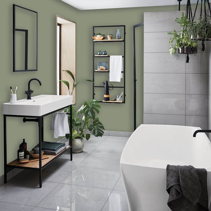 a bath room with a sink and a bath tub next to a wall mounted shelf