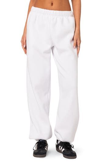 A cozy cotton blend keeps you feeling your best no matter what the day brings when you choose these oversized sweatpants. Elastic waist Side-seam pockets Elastic cuffs 50% cotton, 50% polyester Machine wash, dry flat Imported Relaxed White Cotton Bottoms, Comfortable Cotton Wide Leg Sweatpants, Comfortable Wide Leg Cotton Sweatpants, Oversized Solid Color Joggers For Loungewear, Cotton Wide Leg Joggers With Relaxed Fit, Leisure White Pants With Pockets, Baggy Sweats For Loungewear, Cotton Wide-leg Sweatpants For Lounging, Baggy Full Length Sweatpants For Loungewear