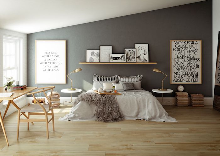 a bedroom with gray walls and wooden floors, white bedding and pictures on the wall