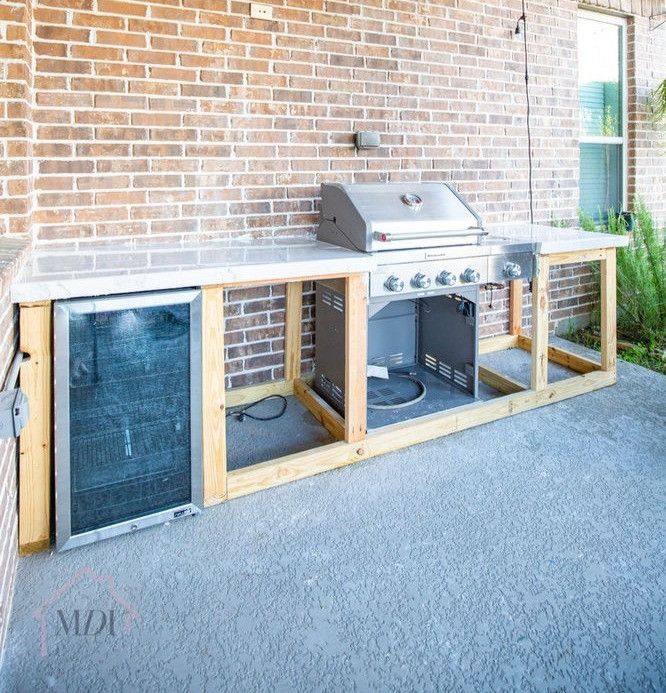 an outdoor grill built into the side of a brick building