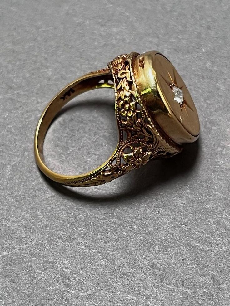 A beautiful victorian era gold ring with diamond.  6 grams 14K Gold Filigree Signet Ring with Diamond  Stamped on the inside band 14k gold A small diamond chip in the center of the signet ring with filigree. Ring is size 5 Weight: 6 grams  Marked 14 K (gold) Condition: very fine with light signs of wear from age. Please see the images for details. If you have any questions or need more images, please feel free to email me.  I am happy to send more images and answer any questions you may have. Victorian Signet Ring, Signet Ring With Diamond, Gold Ring With Diamond, Ring With Diamond, Signet Rings, Baltimore Md, Gold Filigree, Filigree Ring, Signet Ring