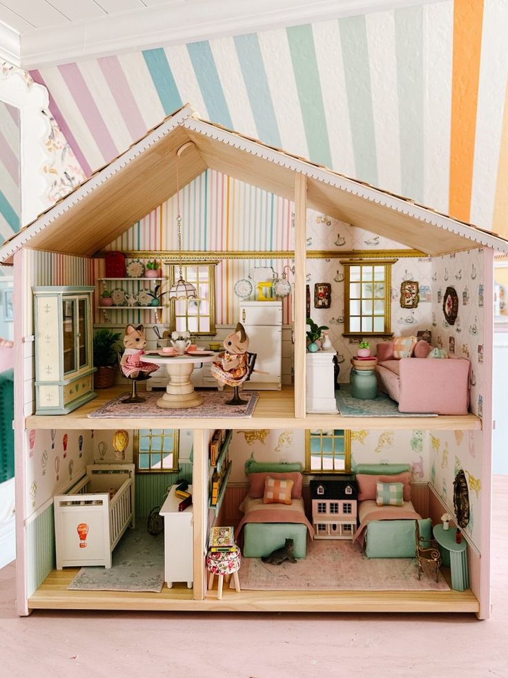 a doll house is shown with furniture and decor on the inside, as well as children's toys