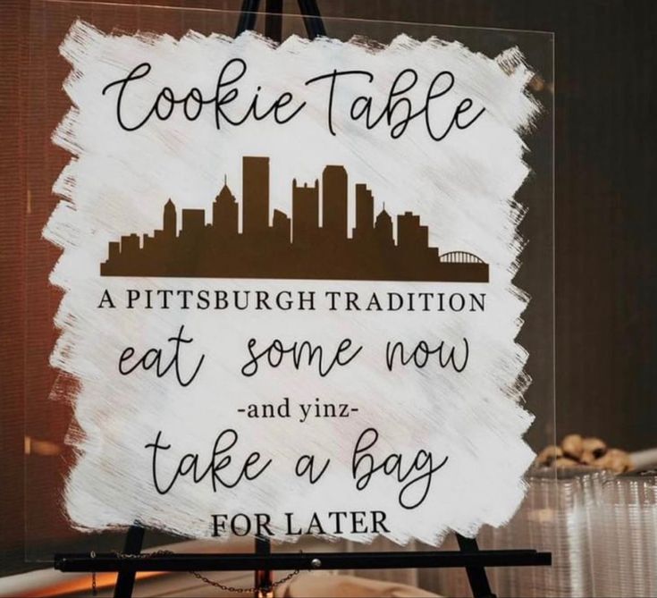 a sign that says cookie table at some now and take a bag for later on it