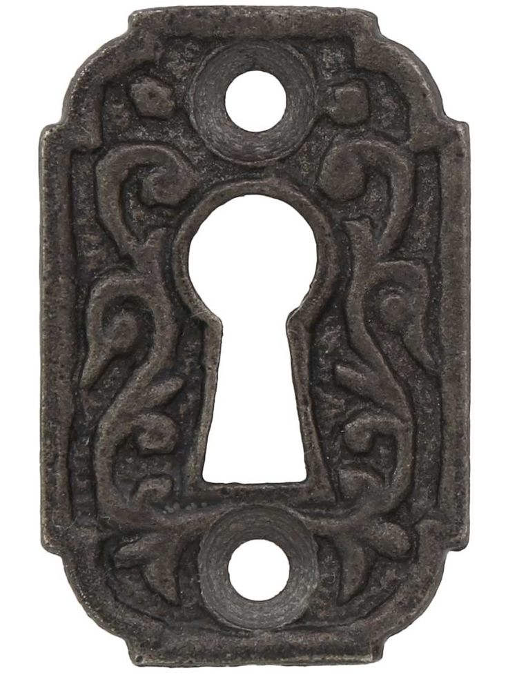 an antique iron door handle with a keyhole and ornate design on the front, isolated against a white background