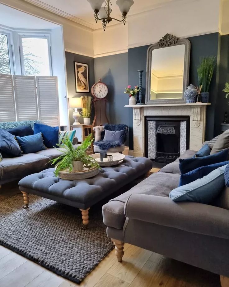 a living room filled with furniture and a fire place in the middle of the room