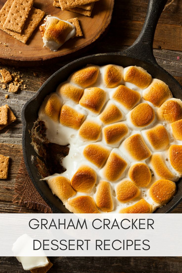 a skillet filled with marshmallows on top of a wooden table next to other items