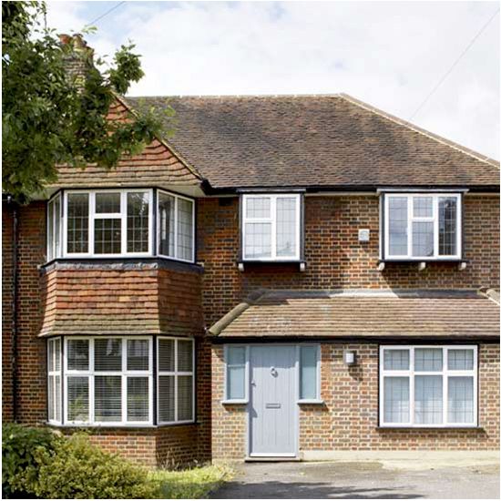 a large brick house with white windows and shutters