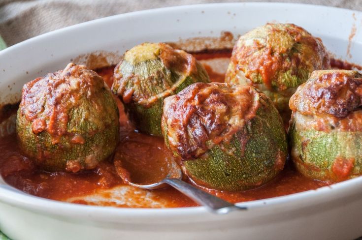 a white bowl filled with meatballs covered in sauce