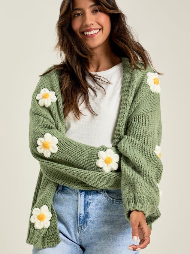 The thick-knit material is so soft, and the adorable daisies throughout are a perfect touch. Layer this with your favorite bodysuit and jeans for an effortless look. Style Taylor Swift Cardigan, Chic Chunky Knit Sweater For Spring, Trendy Textured Knit Sweater For Spring, Soft Knit Spring Cardigan, Trendy Knitted Sweater For Day Out, Soft Knit Cardigan For Spring, Trendy Spring Knitted Cardigan, Fitted Chunky Knit Spring Cardigan, Fitted Chunky Knit Cardigan For Spring