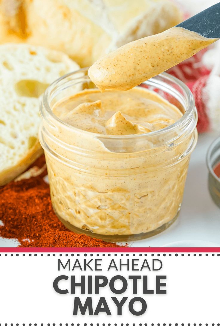 homemade chipotle mayo in a glass jar with bread and garlic on the side