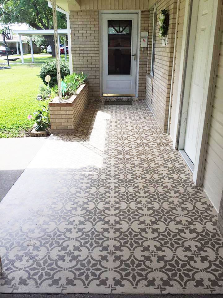 the front porch is decorated with cement tiles