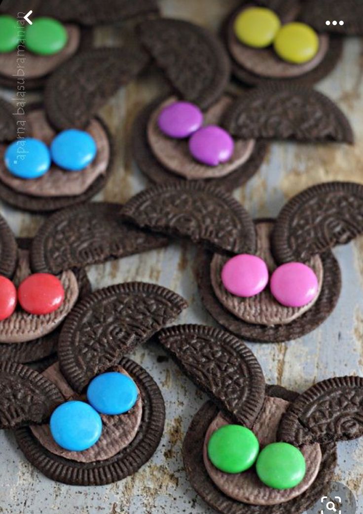 cookies decorated with chocolate and candy are sitting on a table