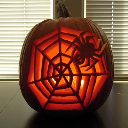 a pumpkin carved to look like a spider web