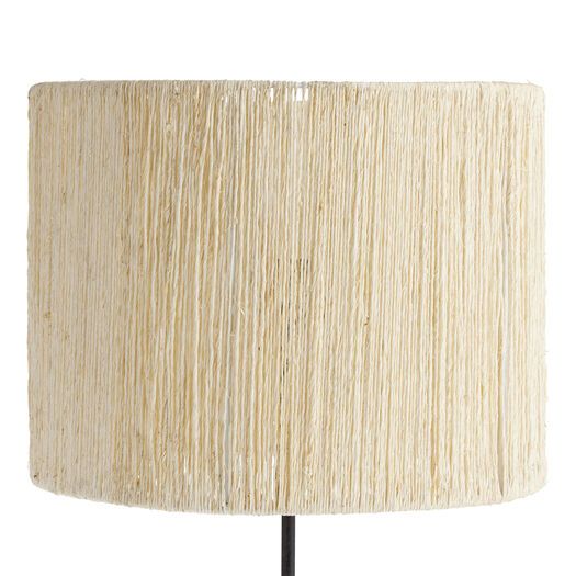 a lamp that is on top of a wooden stand with a white shade over it