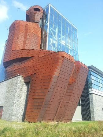 a tall building with a large brick structure on top of it's head and neck