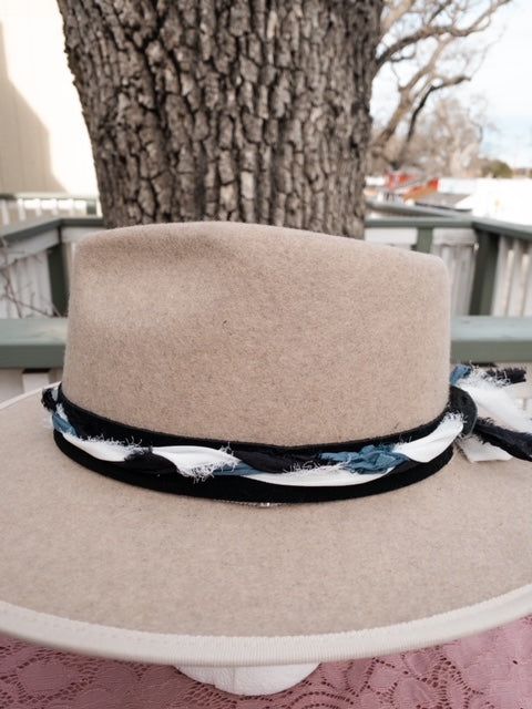 Ready to add a little twist to your brim? The band is 22.5" x 1.5" and has adjustable ties in the back so it can fit hats from 22.5-34". The bottom layer is soft black suede that will look good on all hats. The top layer has is silk ribbons that have been braided to complement the leather and really bring the colors to life. The blue, white, silver and black will compliment your hat. As with all of our custom-made pieces each piece is unique and little different each time made. Please let us kno Adjustable Hat Bands For Country Events In Fall, Adjustable Country Hat Bands For Fall, Adjustable Western Hat Bands For Fall, Western Adjustable Hats For Fall, Adjustable Top Hat For Country Events In Fall, Adjustable Fedora For Country Events, Western Style Top Hat With Adjustable Short Brim, Adjustable Short Brim Top Hat For Rodeo, Adjustable Flat Crown Hat For Fall