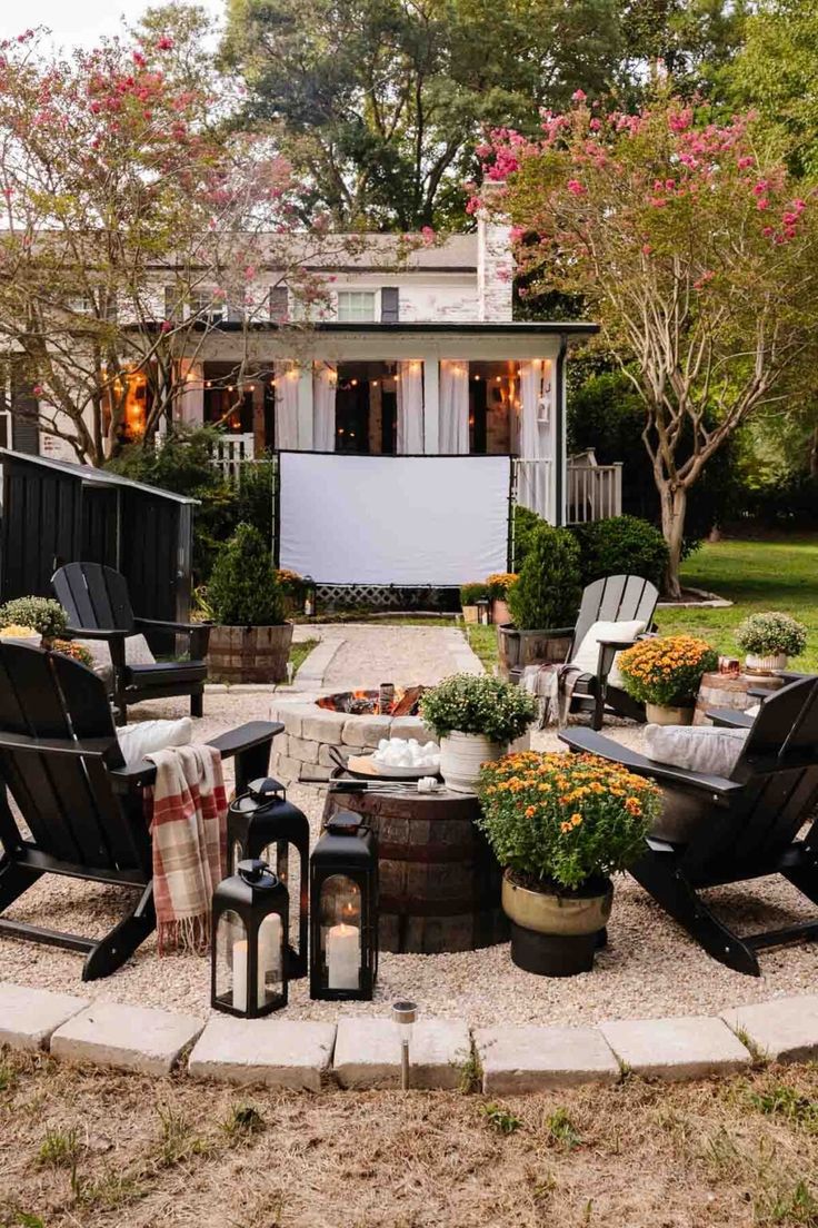 an outdoor patio with chairs, tables and potted plants in the middle of it