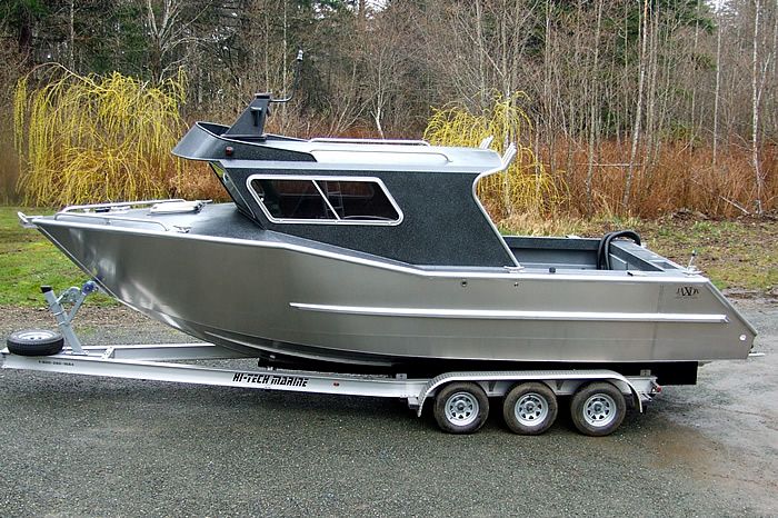 a silver boat sitting on top of a trailer