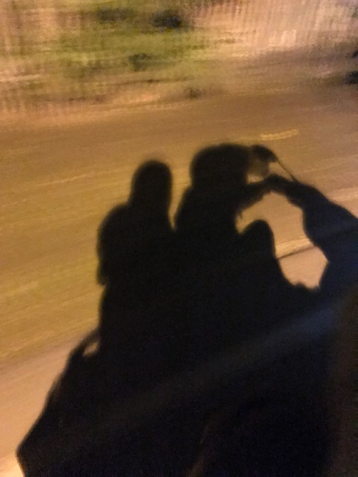 two people riding on the back of a motorcycle