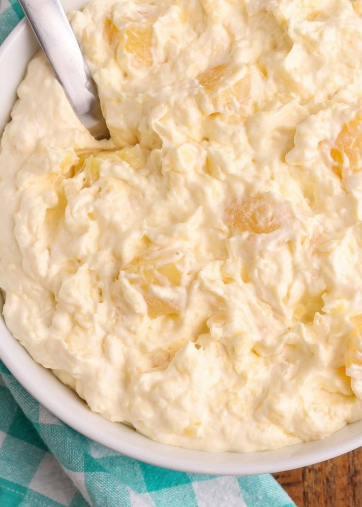 a white bowl filled with food on top of a blue and white checkered table cloth