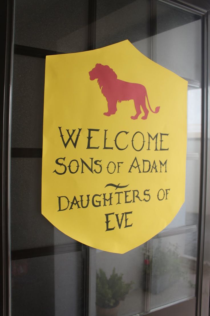 a yellow sign that says welcome sons of adam daughters of eve on the side of a glass door