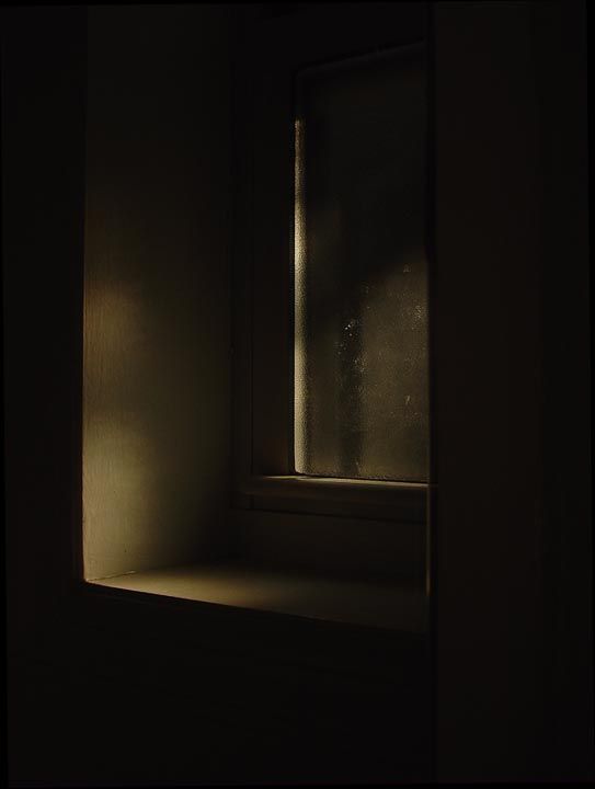 an empty window in a dark room