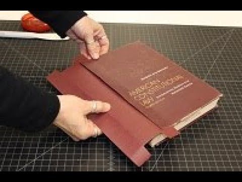 a person is cutting up a book on a table