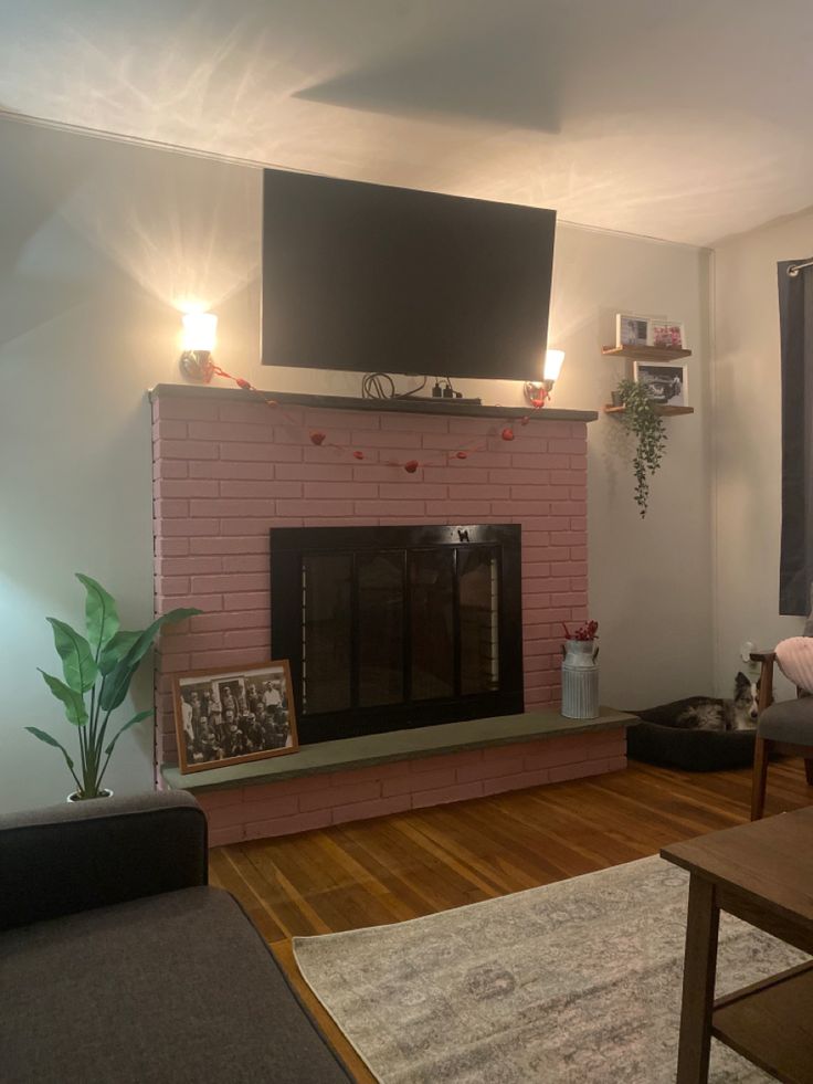 a living room with a fire place and television above the fireplace