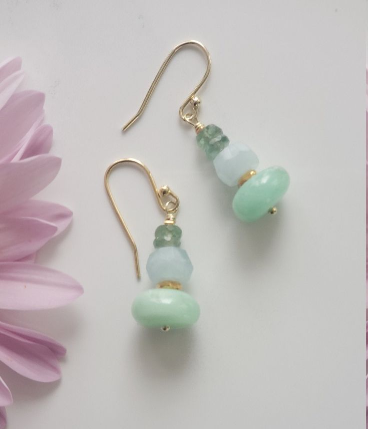 These are very feminine Bar Earrings with Crysoprase (10 mm) Aquamarine (6 mm) and Green Apatite faceted beads (3.5-4 mm) with disk spacer beads made of 925 Solid Sterling Silver plated 24K Gold (Vermeil). All metal components are Vermeil. These earrings are 3-3.5 centimeters long. Milky Aquamarine Faceted Roundelle beads: 7-8 mm, Grade AAA Chrysoprase Smooth Roundelle beads: 11-12 mm, Africa, Grade AA Green Apatite faceted beads: 3.5-4.5 mm, Grade AAA Designed and Made by AnGjewelry! They will be delivered in a cute gift box! ♡ Aquamarine is the birthstone for March. Aquamarine Gemstone Beads Jewelry As Gift, Gold Aquamarine Jewelry With Gemstone Beads, Elegant Amazonite Earrings As A Gift, Adjustable Beaded Aquamarine Jewelry, Feminine Bar, Elegant Amazonite Earrings For Gift, Gold Chrysoprase Earrings For Gift, Gold Chrysoprase Earrings As A Gift, Handmade Gold Earrings With Chalcedony