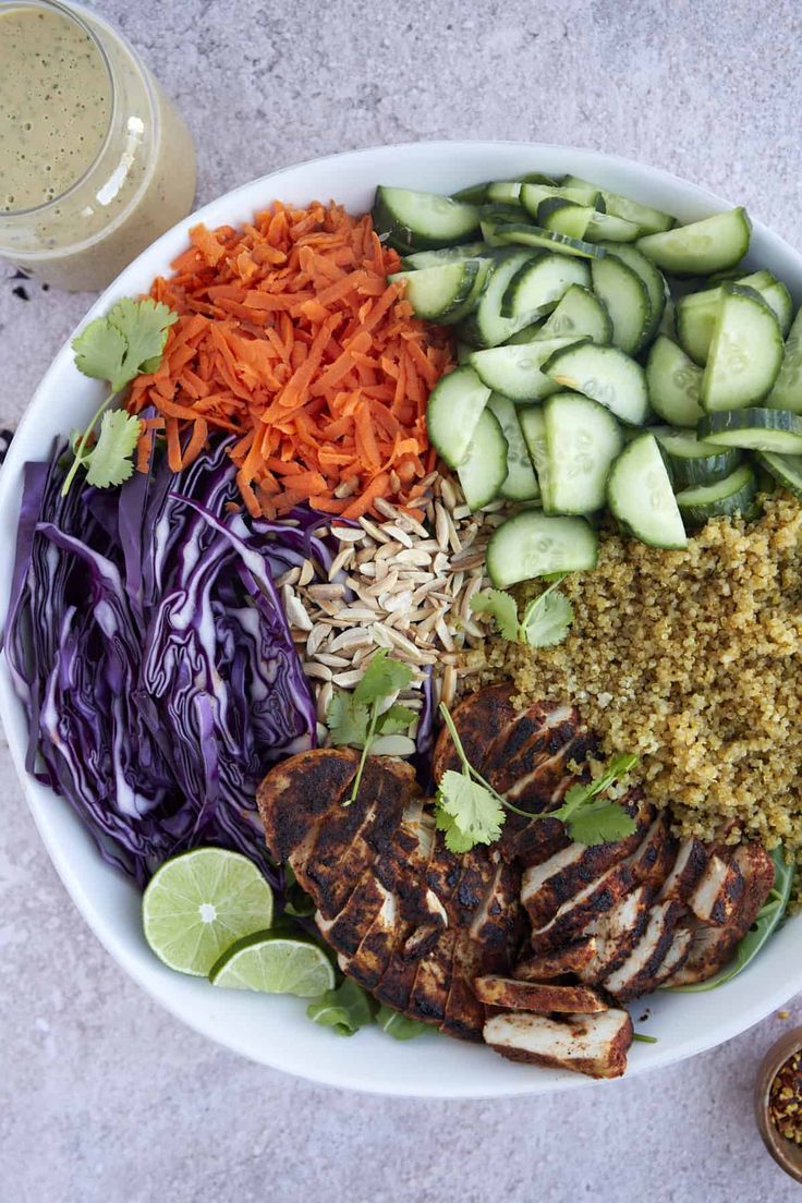 a white bowl filled with meat and veggies