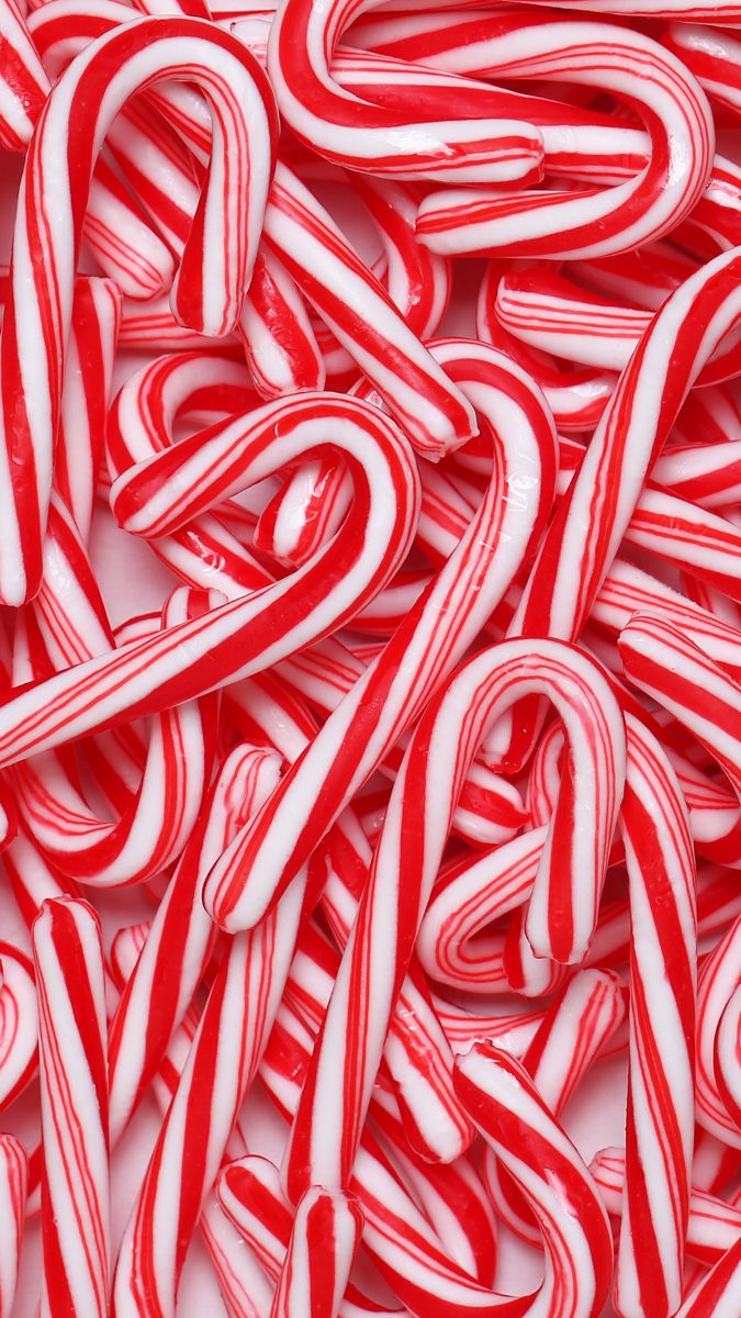 red and white candy canes are stacked together