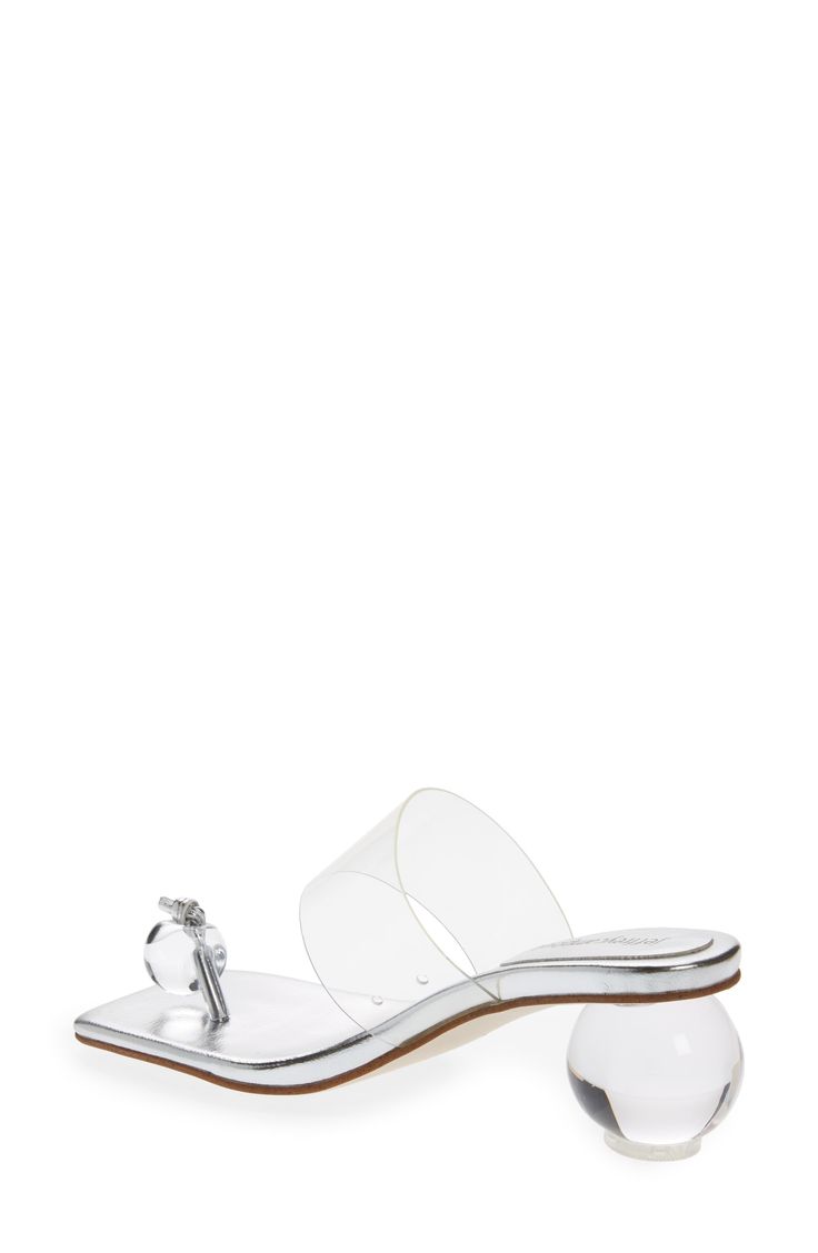 This sandal takes minimalist glamour to new heights with a single bead in place of a toe strap and a transparent heel that echoes the orb shape. 2 1/2" heel (size 8.5) Synthetic upper/leather lining/synthetic sole Imported Women's Shoes Clear Strap Open Toe Sandals, Clear Sandals With Open Heel And Clear Strap, Clear Sandals With Open Heel, Clear Open Toe Sandals For Wedding, Clear Sandals For Summer Cocktail Events, Formal Silver Sandals With Clear Strap, Silver Sandals With Clear Strap For Evening, Elegant Sandals With Clear Strap And Synthetic Material, Clear Sandals For Spring Wedding