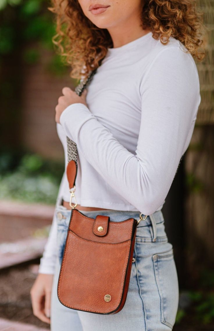 Looking for the bag that will take you from brunch, to a festival, to errands, and back again? The Robyn has you covered. This women's crossbody is the perfect size for holding your essentials, and the convenient front pocket will keep your phone easily accessible for capturing a feed-worthy meal or recording your favorite artist in concert. The Robyn also includes a detachable adjustable strap, so you can wear it however it's most comfortable for you. Prepare to be stopped by strangers asking y Versatile Shoulder Phone Bag For On-the-go, Versatile Phone Shoulder Bag For On-the-go, Trendy Phone Bag With Pockets For Travel, Versatile On-the-go Shoulder Phone Bag, Trendy Phone Bag With Hidden Sleeve For On-the-go, Fall Satchel Phone Bag For Everyday Use, Fall Everyday Use Satchel Phone Bag, Brown Phone Bag With Cell Phone Pocket For On-the-go, Fall Crossbody Shoulder Bag With Cell Phone Pocket