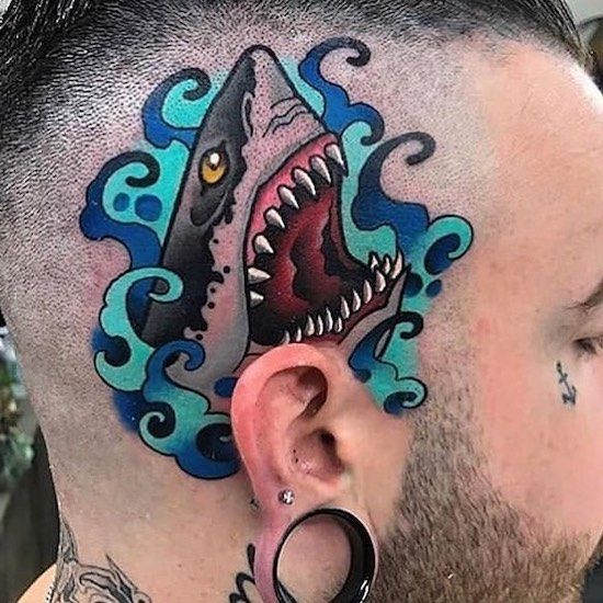 a man with a shark tattoo on his head