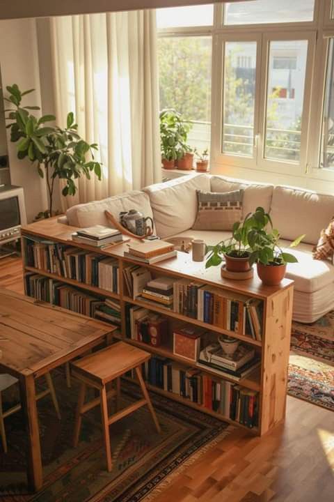 a living room filled with furniture and lots of books