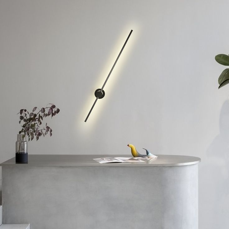 a white table with a yellow banana on it next to a plant and some lights