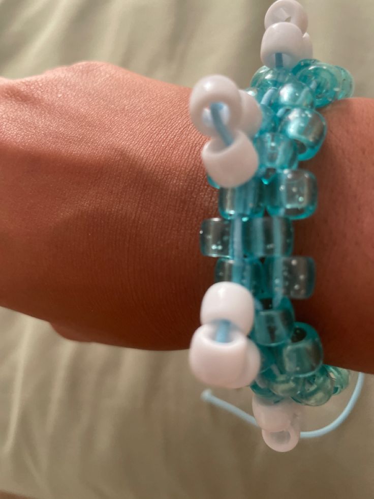 a person's arm with several bracelets made out of beads and glass beads