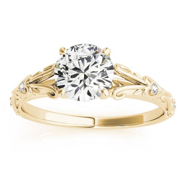 a yellow gold engagement ring with a round diamond in the center and scrolls around it