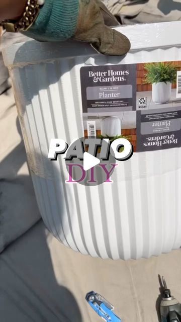 an advertisement for patio diy is displayed on the back of a large bucket with plants in it