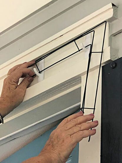 a man is holding the door frame with his hands