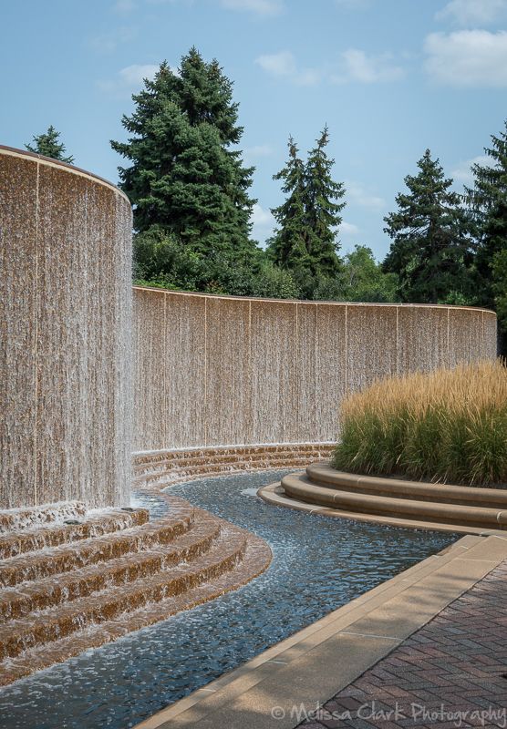 a large water fountain in the middle of a park