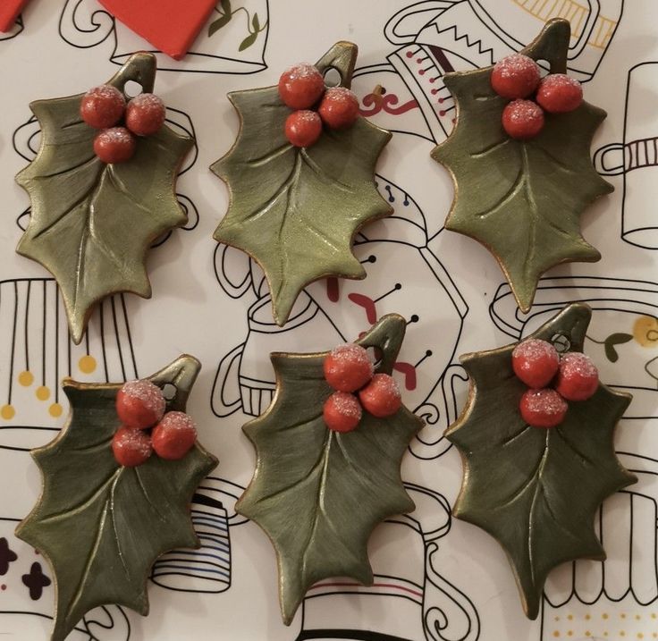 christmas cookies decorated with holly leaves and red berries