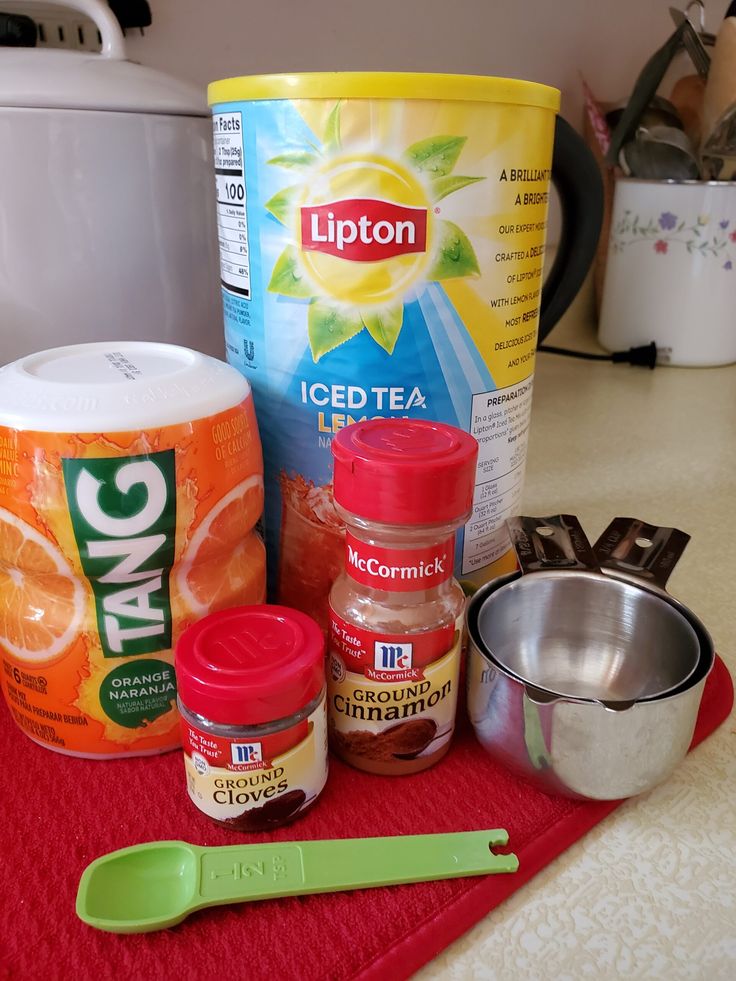 ingredients to make orange cake sitting on top of a red mat next to a canister