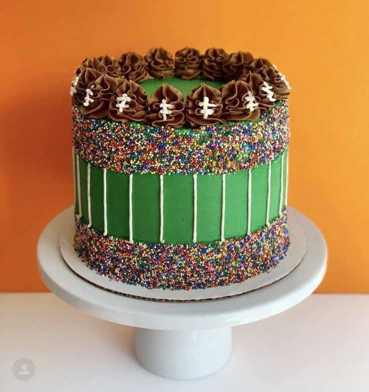 a cake with chocolate frosting and sprinkles on top sitting on a plate