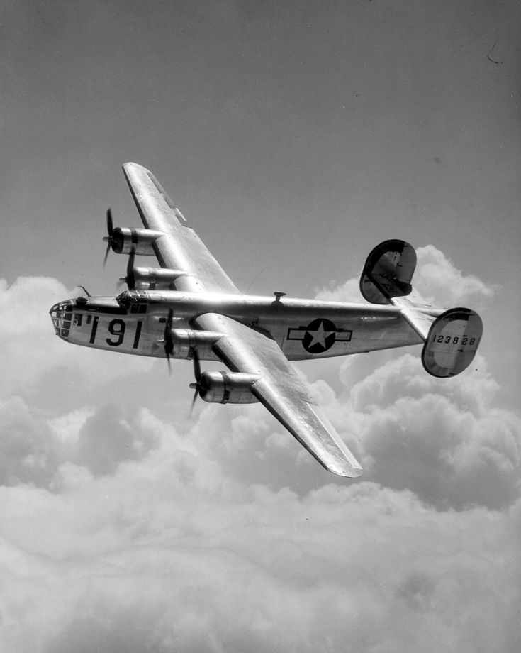 an old airplane flying in the sky above clouds