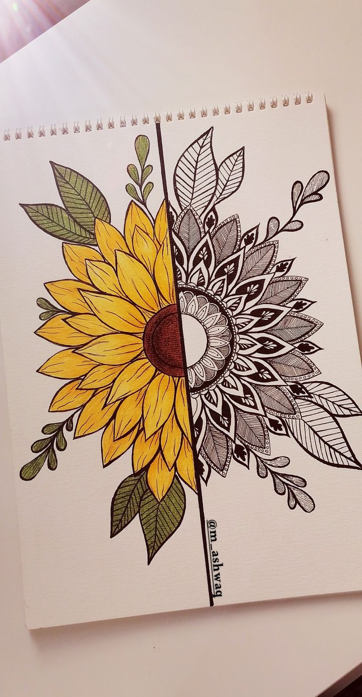 a drawing of a sunflower on top of a spiral notebook with leaves and flowers