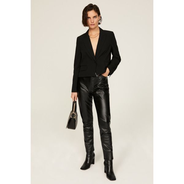 Black faux leather (53% Polyurethane, 47% Polyester). Pants. Front button closure. 28" inseam. 12" rise. Imported. Fitted Faux Leather Pants With Button Closure, Fitted Leather Pants With Faux Front Pockets, Trendy Workwear Pants In Polyurethane, Edgy Leather Straight Pants For Work, Leather Pants With Faux Front Pockets For Night Out, Edgy Straight Leather Pants For Work, Trendy Fitted Leather Pants With Button Closure, Modern Bottoms With Button Closure For Fall, Black Polyurethane Leather Pants For Work