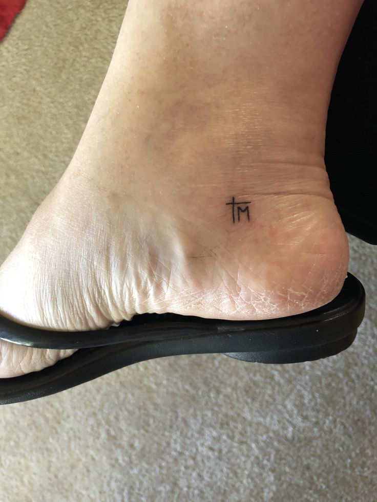 a person with a small tattoo on their foot that says pi above the word pi