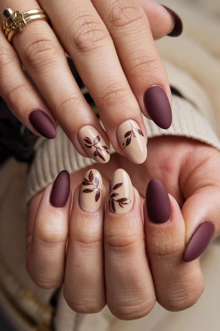 Transform your natural nails this season with stunning fall nail ideas that capture the essence of autumn. Picture a rich burgundy base adorned with delicate gold leaf accents, creating a warm, cozy vibe perfect for any occasion. Let your nails reflect the beauty of falling leaves and crisp air while keeping it chic and natural. Get inspired to embrace the elegance of fall! Burgundy Nails With Flower Design, Dainty Winter Nails, Natural Nail Fall Designs, Maroon Football Nails, Gold Leaves Nails, Autumn Nails With Leaves, Cute Maroon Nails, Easy Natural Nails, Minimalistic Fall Nails